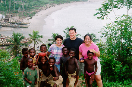 Members of the team with children at a fishing village near Cape Coast.